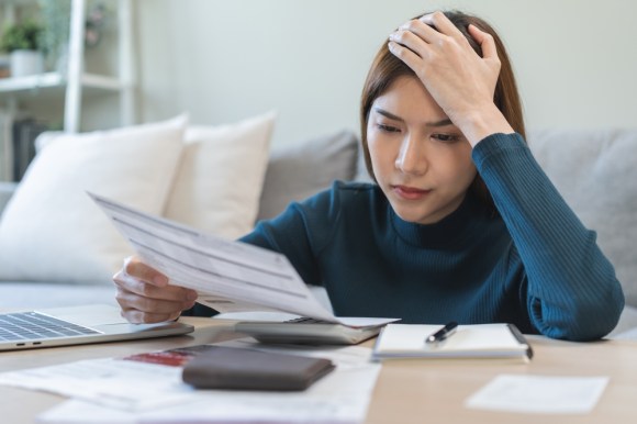 Woman looking stressed while reviewing bills