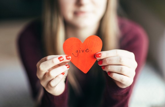 Girl holding giving heart