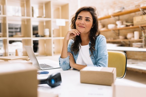 Small business owner sitting in her workspace