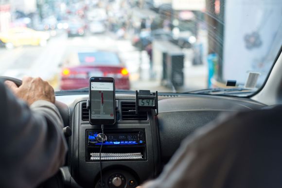 Rideshare driver navigating in their car.