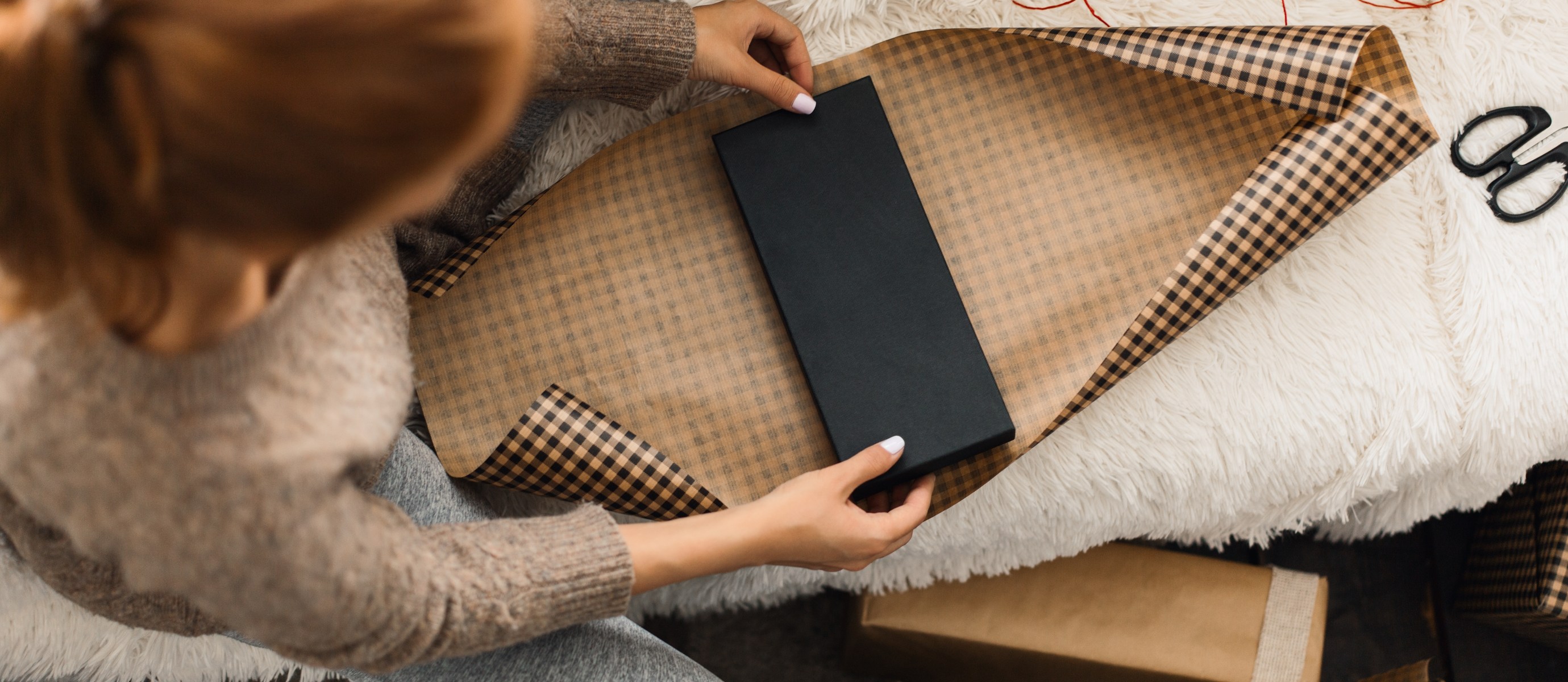 woman wrapping a gift