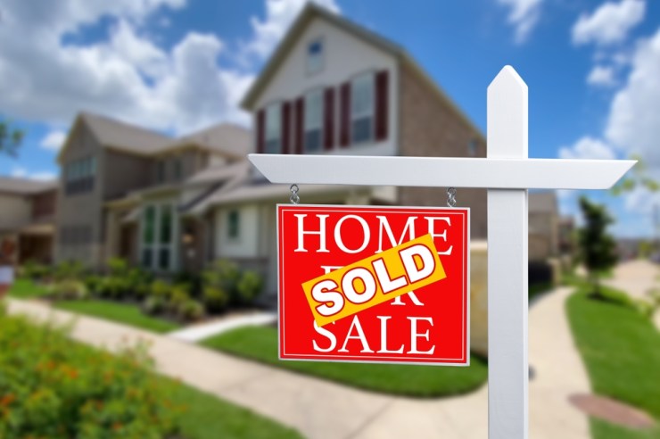 For sale sign in front of a house.