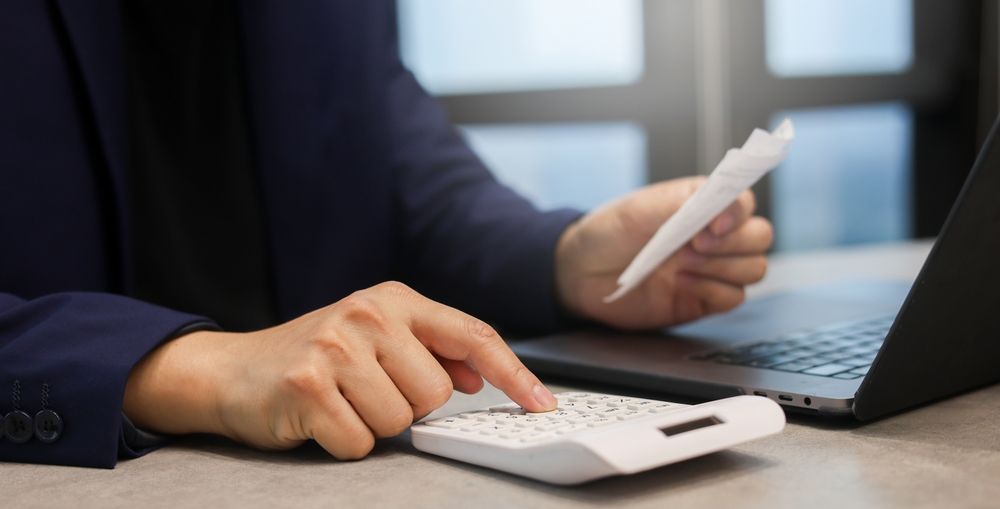 Office worker using calculator.