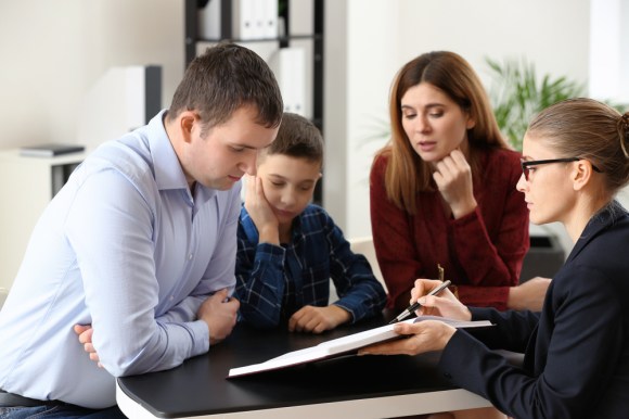 Family sitting with attorney reviewing document