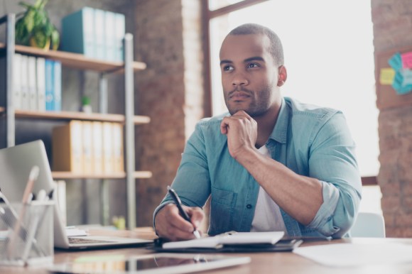 Man considering a decision while sitting in an office.