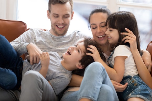 Young family sitting on the couch.