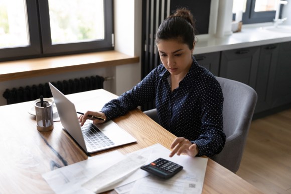 Woman doing tax preparation at her desk.