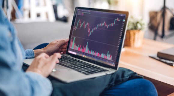 Woman checking stock performance on her laptop.