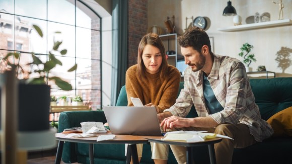 Couple doing their taxes in the living room.