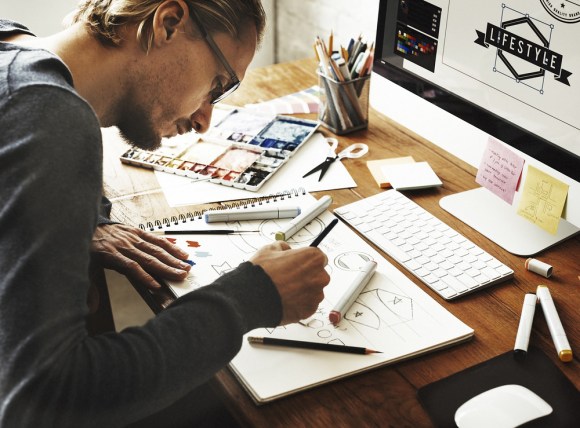 Young man working on logo designs.