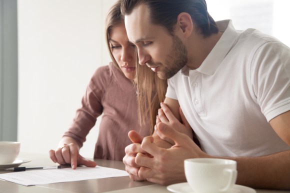 Husband and wife looking over a document together.