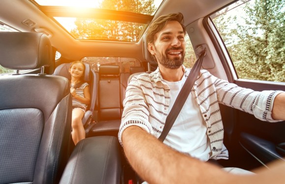 Dad and kid driving in car.