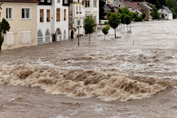 Flooded neighborhood street in the middle of a natural disaster.