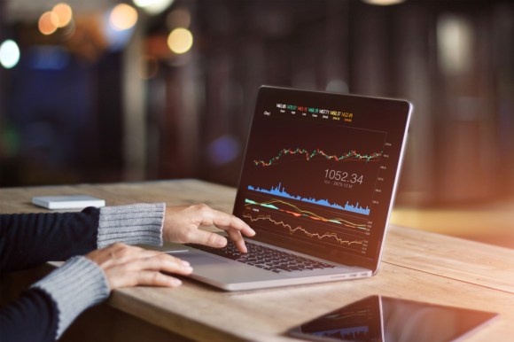 Close-up of a woman tracking investments on her laptop.
