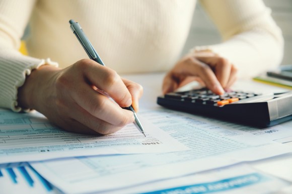 Closeup of a woman filling the form for an Individual Income Tax Return.