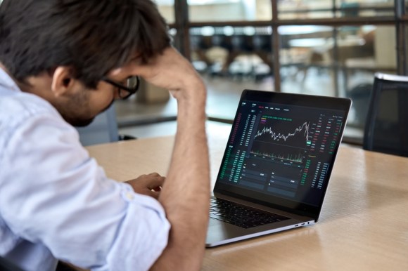 Man watching stock exchange on his laptop.