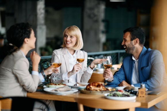 Young professionals discussing business over lunch.