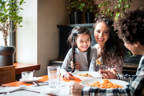 Family having a meal together at the dinner table.