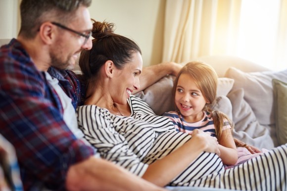 Family sitting on couch.