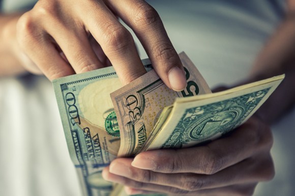 Close-up of someone counting cash.