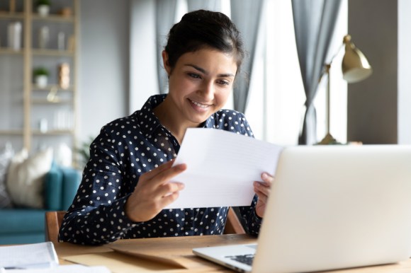 Woman receiving good news in the mail.