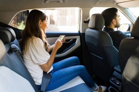 Rideshare driver and passenger in car.