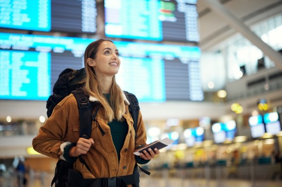 Excited woman at an airport.