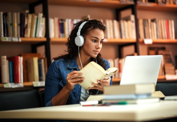 Young college student in library.