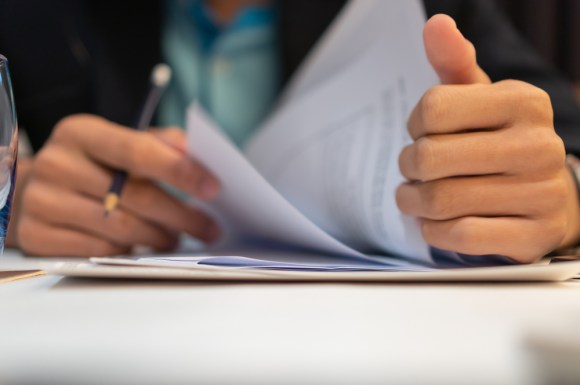 Man going through stack of documents.
