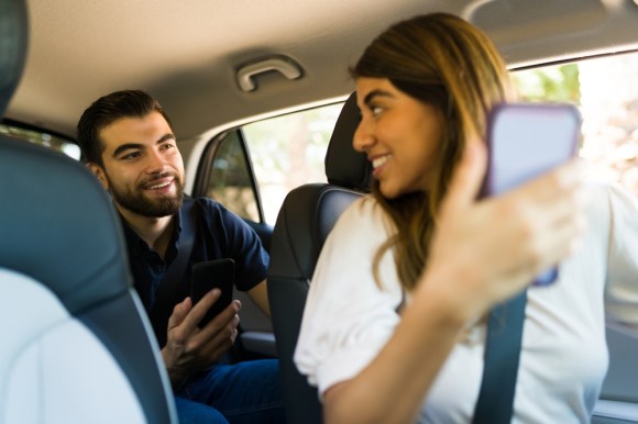 Rideshare driving speaking to passenger.