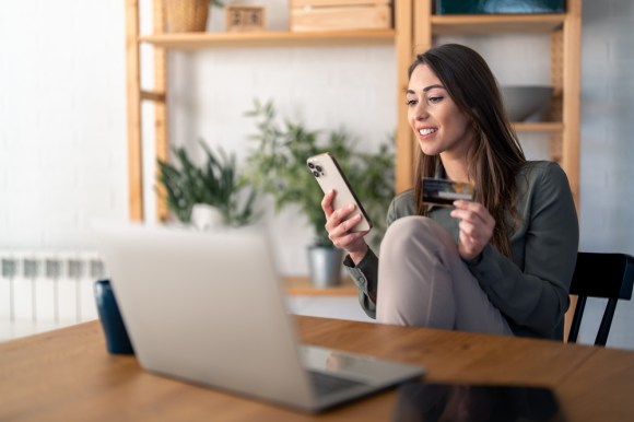 Woman online shopping with credit card.
