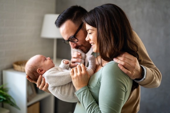 Parents holding baby.