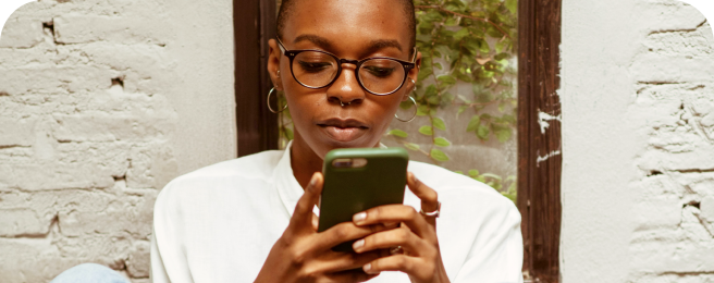 Photo of a user looking at their mobile phone