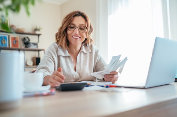 Caucasian woman doing taxes.