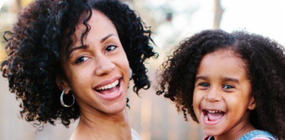 Photo of a mother and daughter smiling