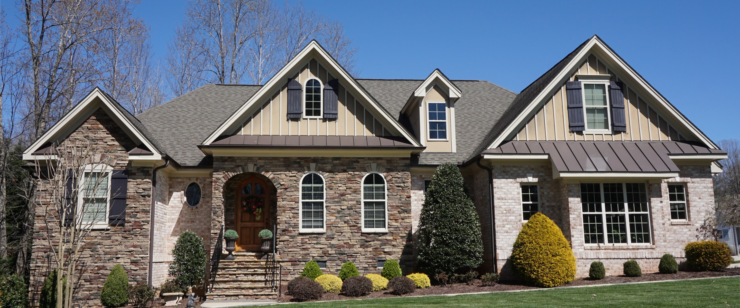 Suburban home with a stone and brick exterior in a neighborhood