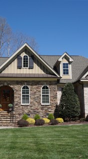 Suburban home with a stone and brick exterior in a neighborhood